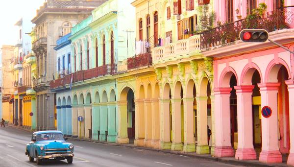 Classic old cars and traditional colorful buildings in downtown Havana, Cuba